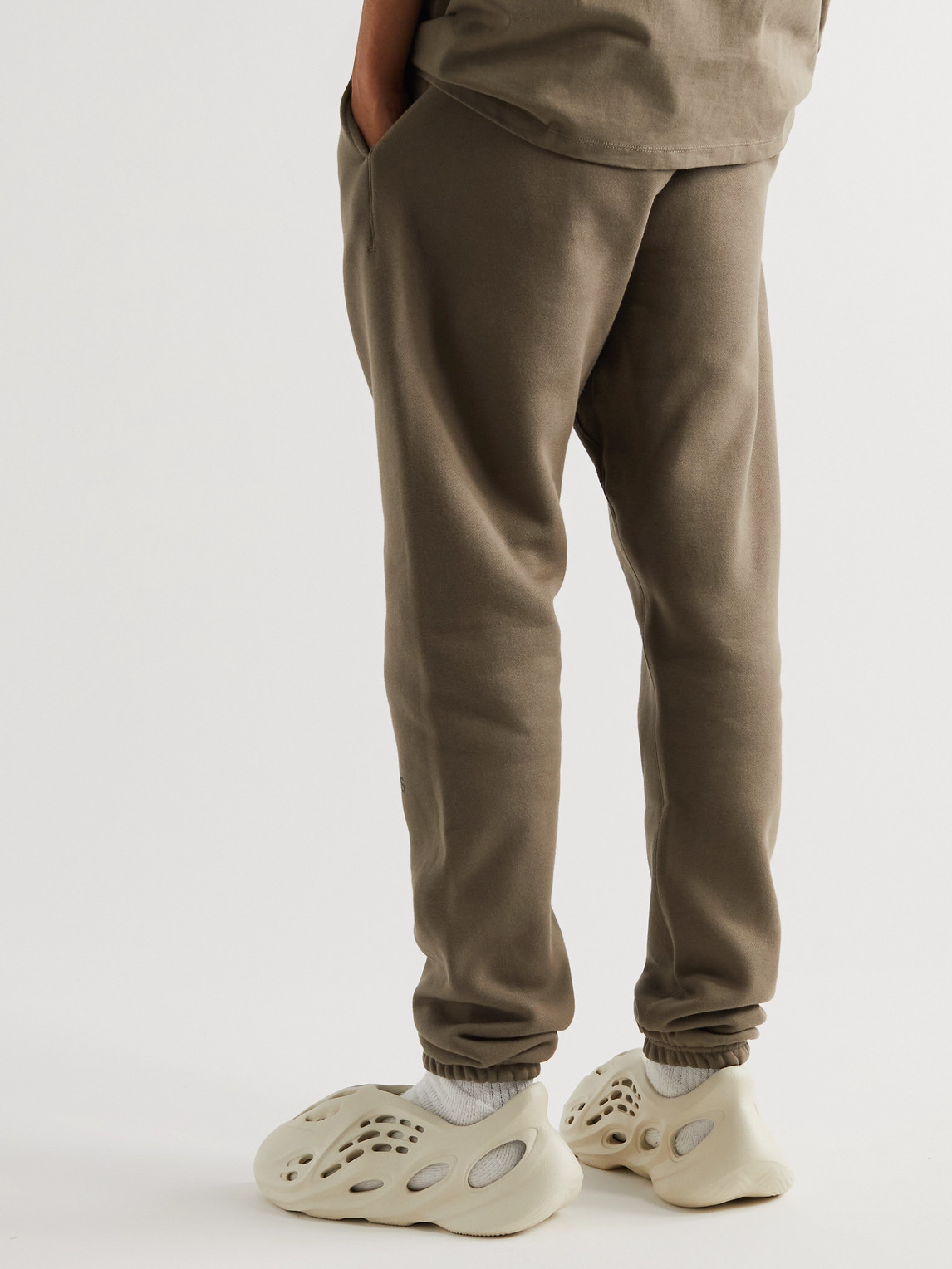 Shop Essentials Tapered Logo-print Cotton-blend Jersey Sweatpants In Brown