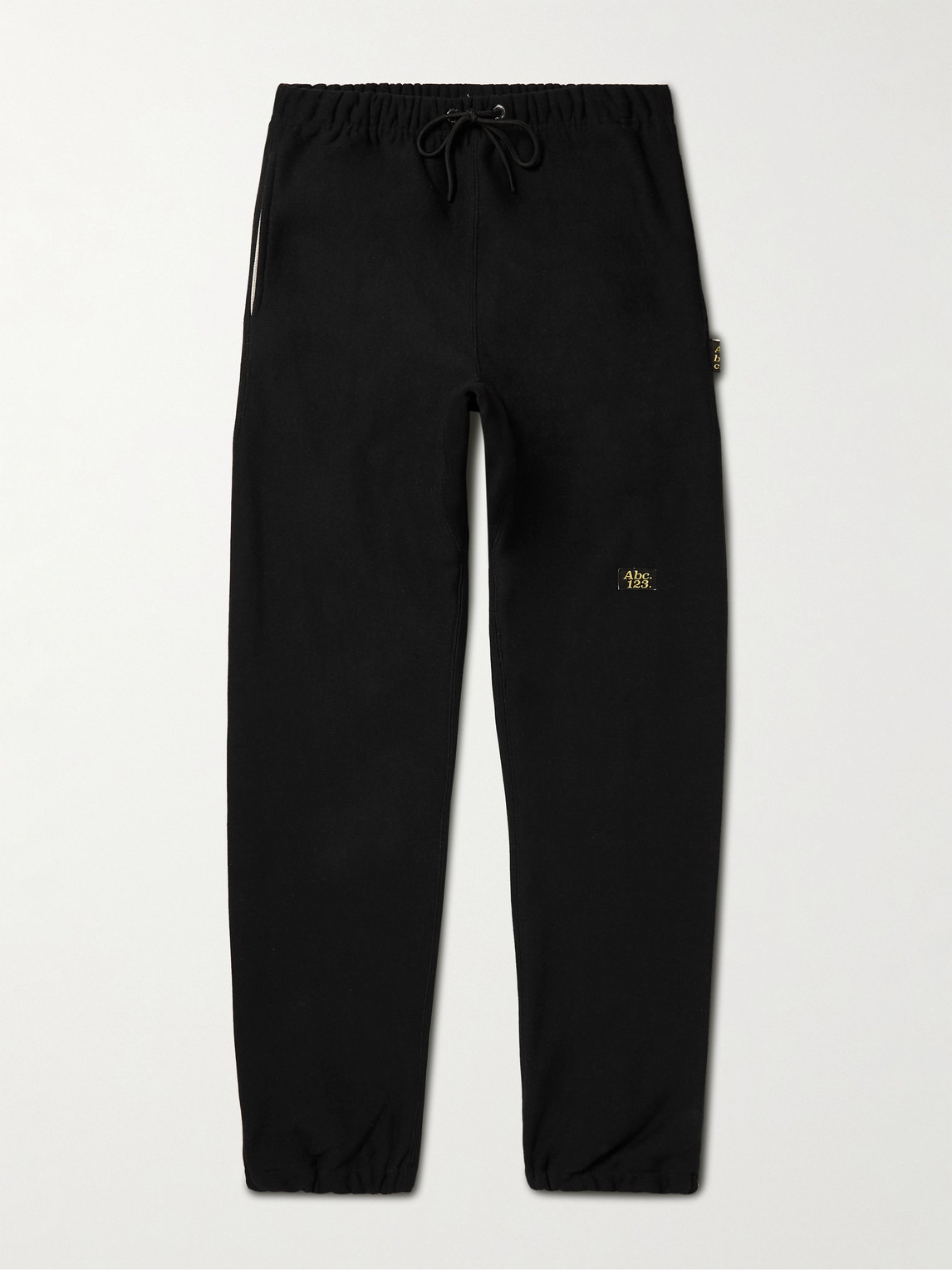 Abc. 123. Tapered Logo-appliquéd Cotton-blend Jersey Sweatpants In Black